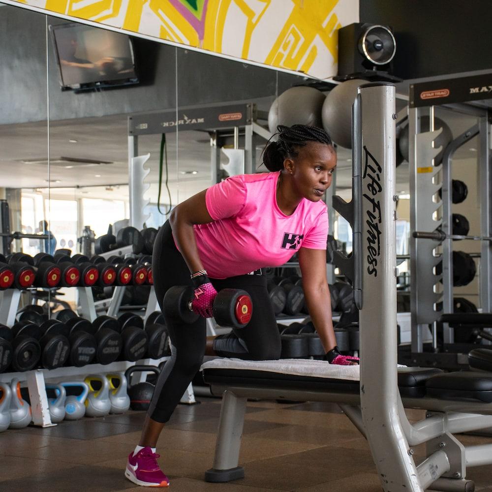 The Boma Nairobi Hotel Buitenkant foto A woman performing a dumbbell row